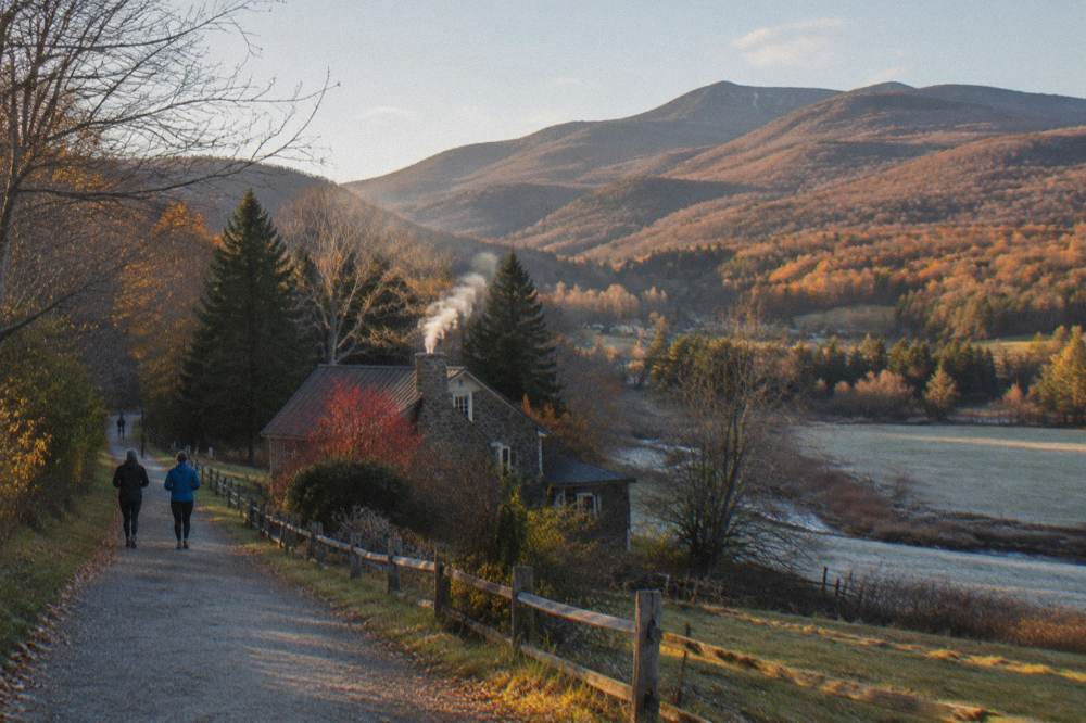 Golden late afternoon light over a Vermont valley with patchy remaining autumn color