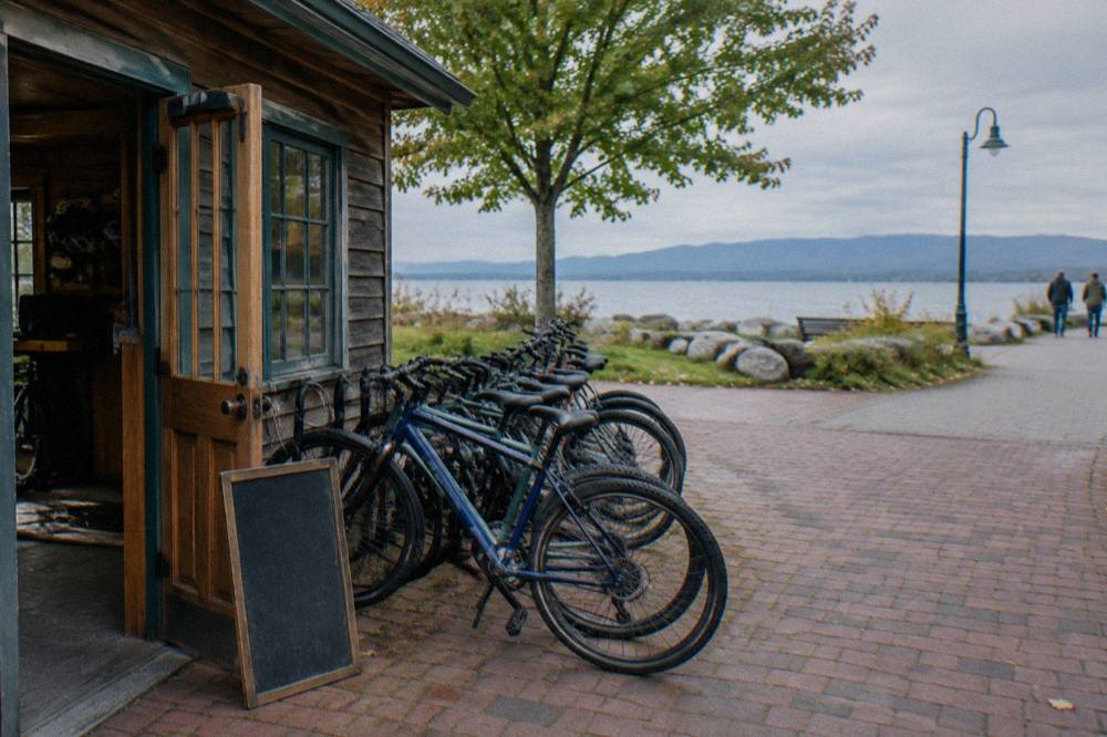 A row of rental bicycles lined up outside a small wooden shop