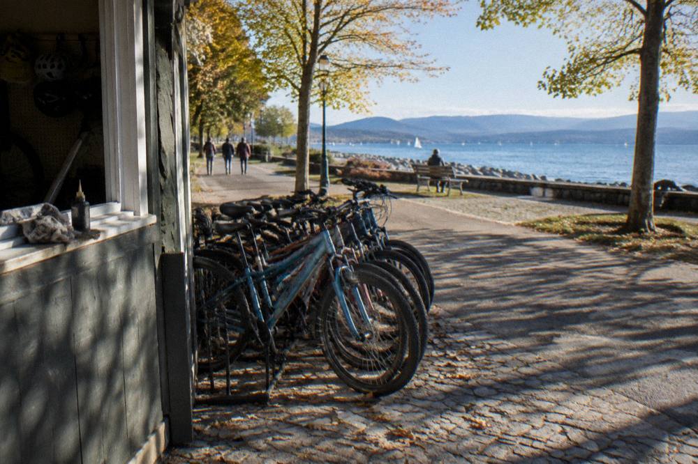 A rental bike stand with bicycles lined up outside a small Vermont shop
